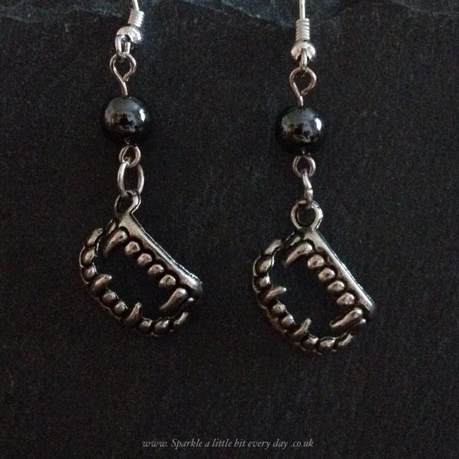 Vampire teeth earrings.