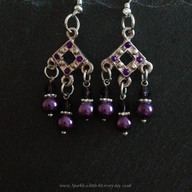 Purple earrings made from glass beads and crystals.