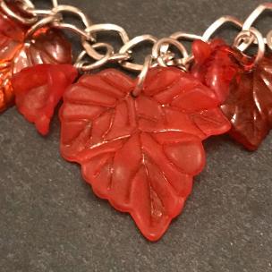 Red flowers bracelet close up of leaf.