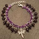 Dragonfly on a purple crystal child's bracelet.