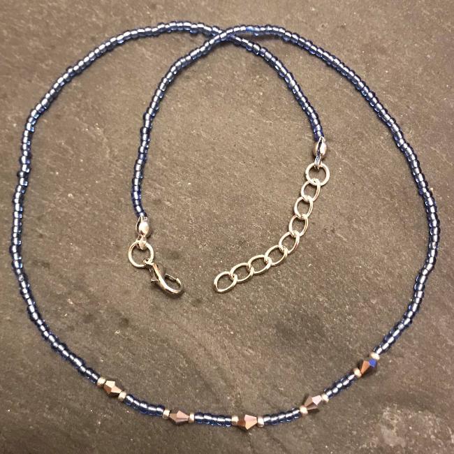 Necklace with blue seed beads and silver bicones.