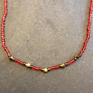 Red seed bead and gold crystal necklace.