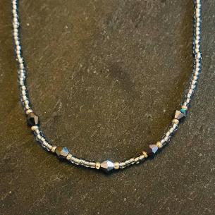 Silver seed bead and silver crystal necklace.