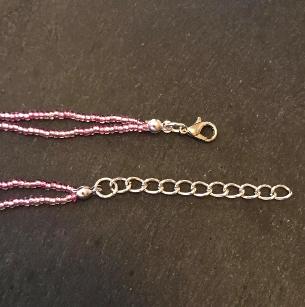Seed bead necklace. Clseo up of the lobster clasp and extension chain.