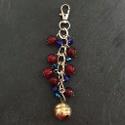Red and blue bell bag charm.