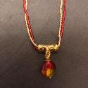 Red and gold glass pendant on a double strand of glass  seed beads.