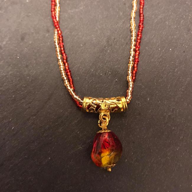 Red and Gold Glass Pendant on a double strand of seed beads.