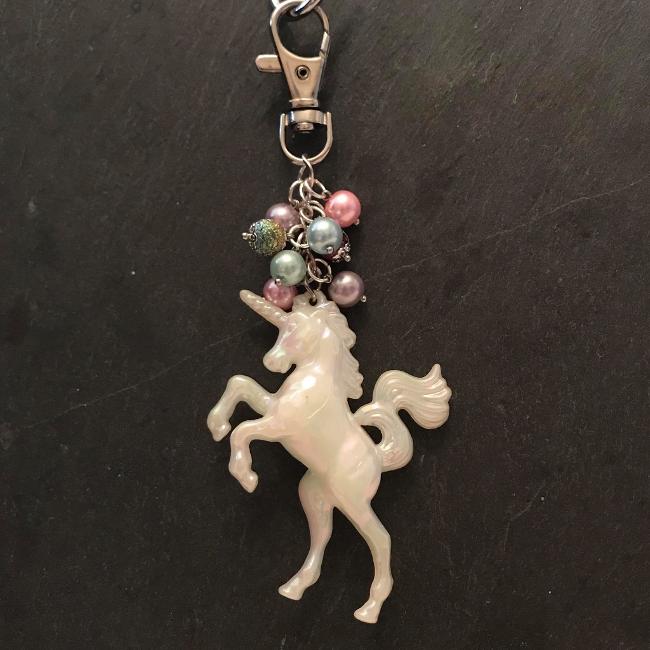 This fun bag charm can clip easily onto your bag, your coat, or anywhere you like. 