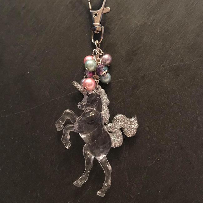 This fun bag charm can clip easily onto your bag, your coat, or anywhere you like.